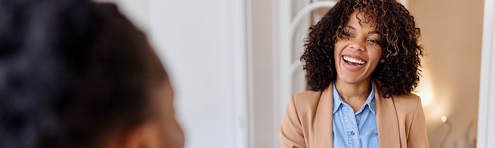 Woman in suit smiling banner
