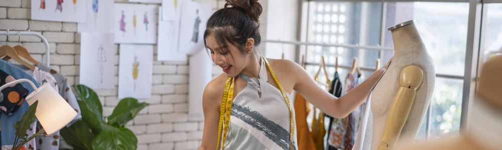 Fashion student working with mannequin in studio